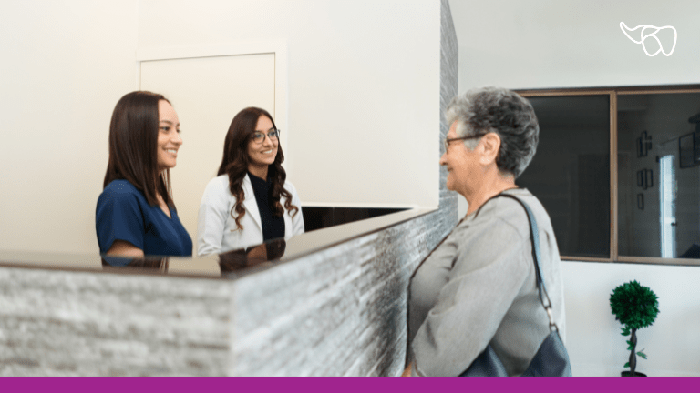 The front office team at a dental practice helps a patient schedule her next appointment