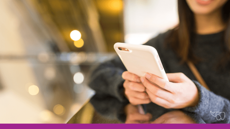 A dental patient receives a text message appointment reminder on her mobile device