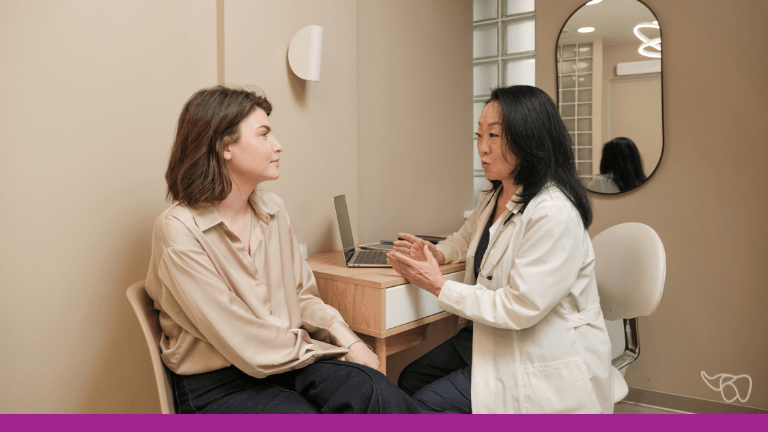 A dental team member calmly discusses a complaint with a patient